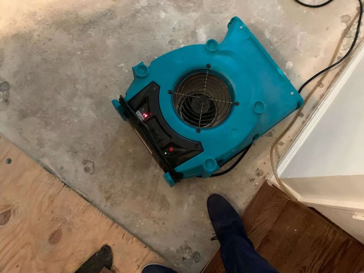 Air mover drying subfloor during Commercial Water Damage Restoration in Huntingdon